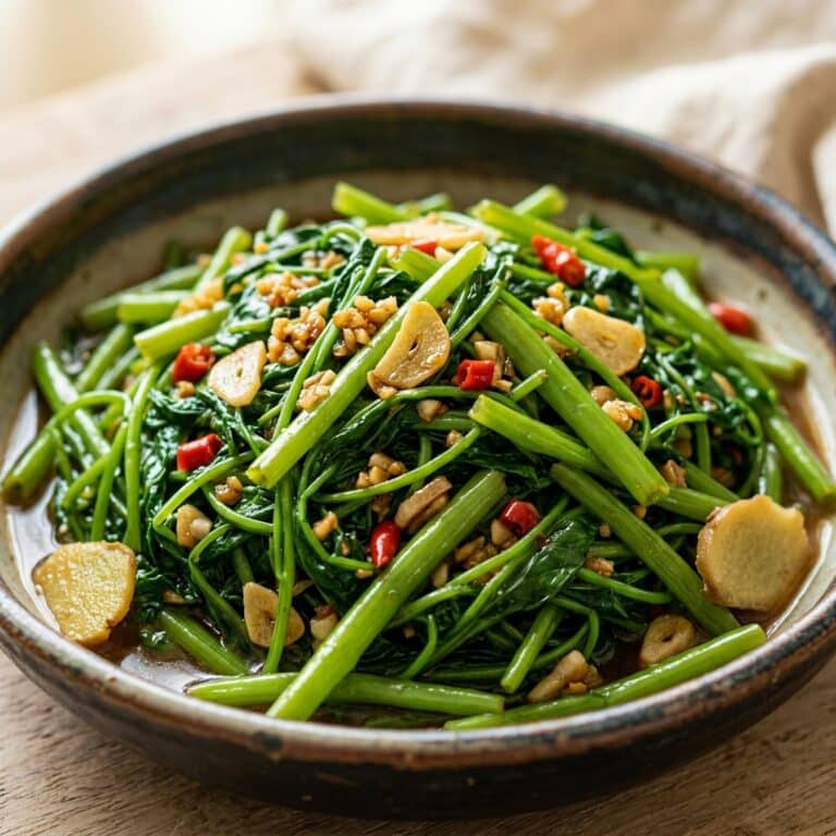 Yes, you can add complementary vegetables to your morning glory vegetable recipe, though add quick-cooking vegetables like mushrooms, bell peppers, or garlic shoots during the last minute of cooking. Avoid adding slow-cooking vegetables like broccoli or carrots to this morning glory vegetable recipe as they require longer cooking times that would overcook the delicate morning glory greens. Keep the morning glory vegetable recipe true to its simple roots by adding only one additional vegetable for best results.